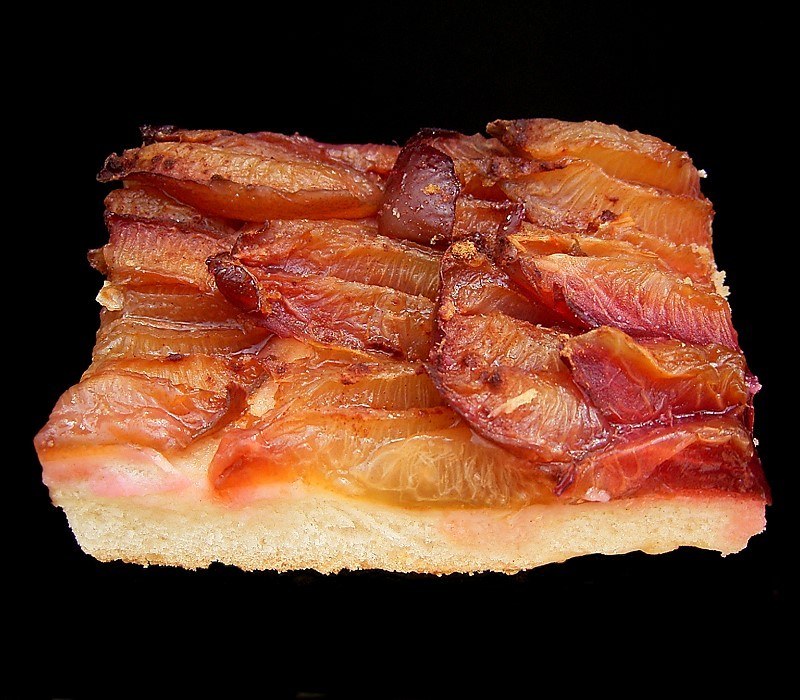 Plum halves arranged over a thin baked yeast base